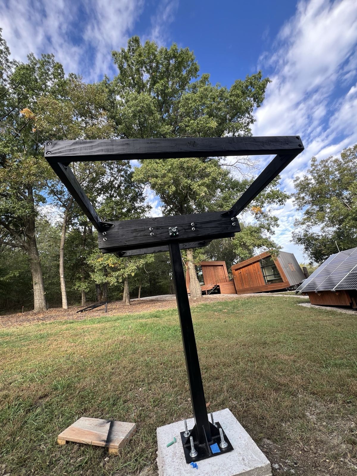 Frame mounted on the mast against a blue sky, pods in the background