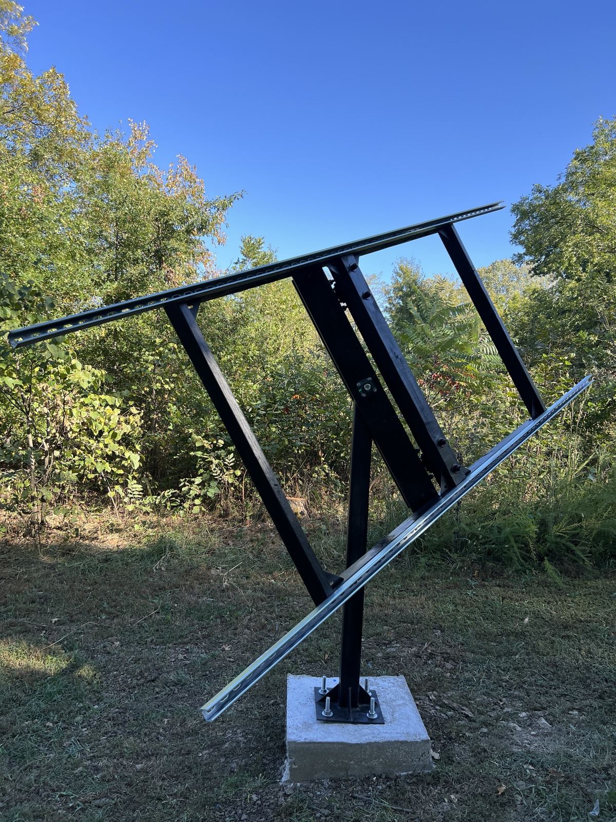 The frame rolled steeply to one side on its mast with rails attached