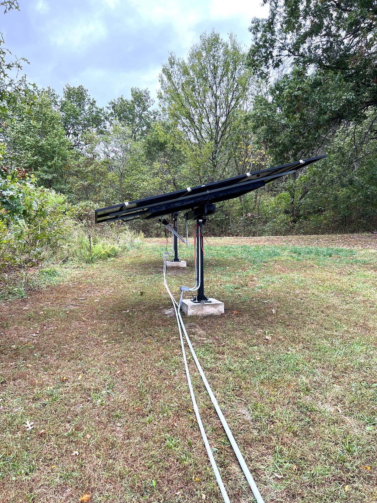 Two dual-axis solar trackers on their concrete piers